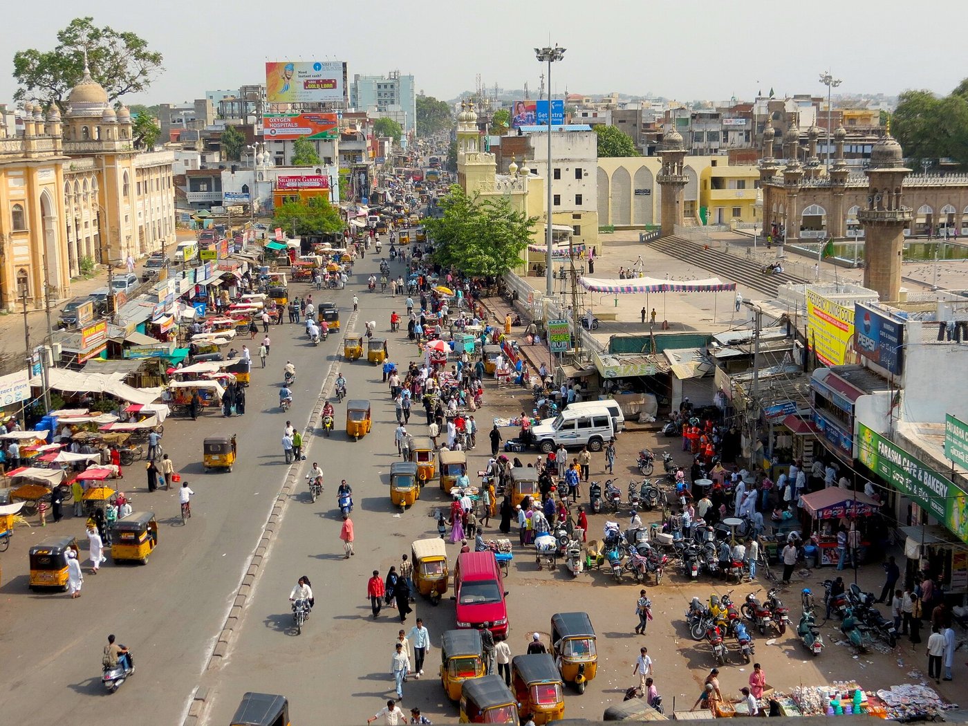 Busy street of autos and shops near the Charminar in Hyderabad, seen from above